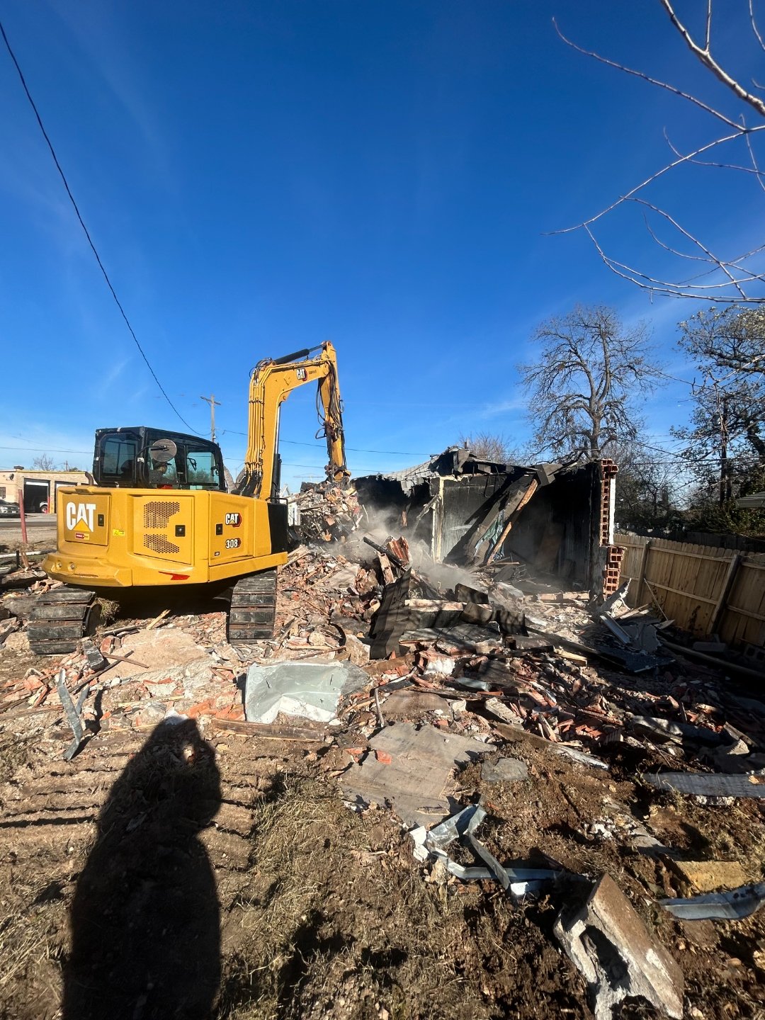 Lifted Construction LLC excavator tearing down a fire-damaged structure during a full demolition project